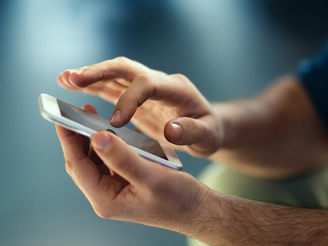 Generic Male hands typing on smartphone. Picture: Istock