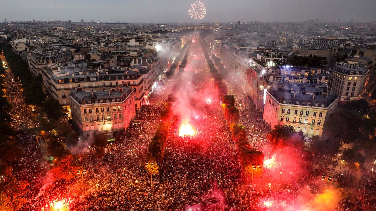 his picture taken from the top of the Arch of Triumph shows people lighting flares as they celebrate after France won the Russia 2018 World Cup