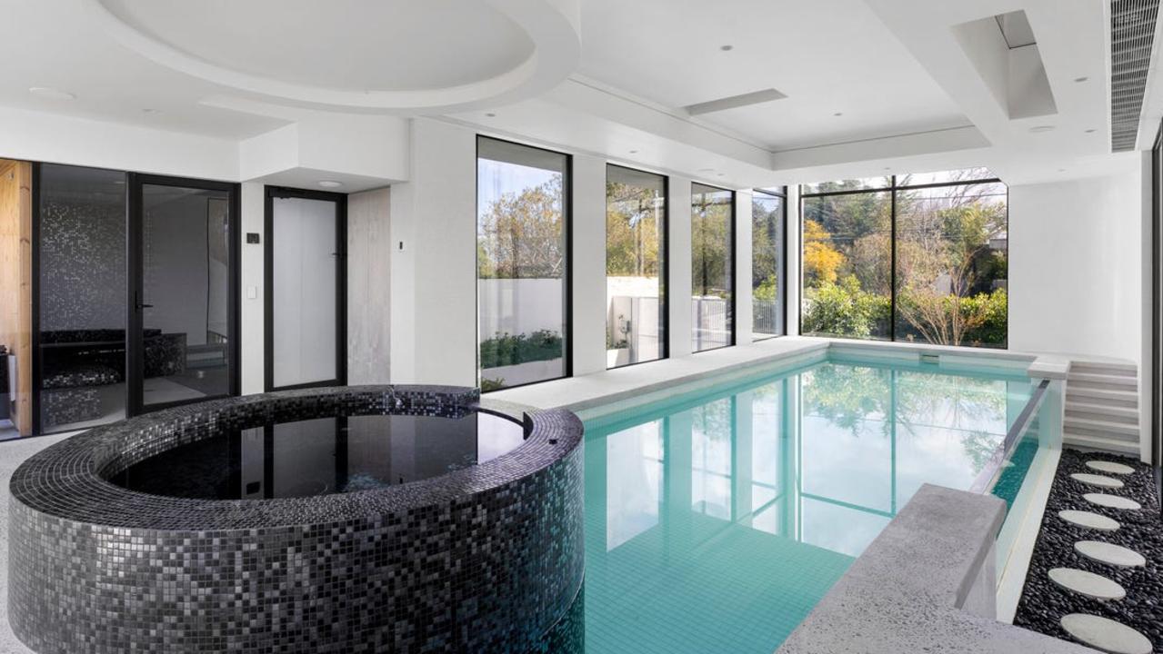 The heated indoor pool has glass sides and a spa.