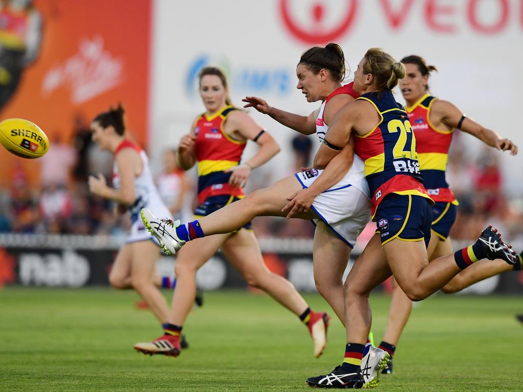 Crows defender Courtney Cramey lays a tackle on Kirsty Lamb of the Western Bulldogs during their Round 1 AFLW clash at Norwood Oval. Picture: AAP Image/Mark Brake