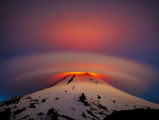 Chile’s most active volcano, Villarrica, has started showing signs of activity after 7 years of dormancy. This photo captures a lenticular cloud illuminated by the glowing lava from the crater. Picture: Francisco Negroni