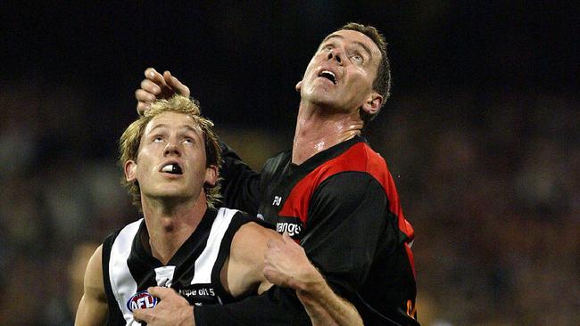 Paul Salmon contests a ruck contest with Collingwood’s Josh Fraser.