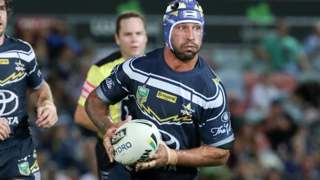 Johnathan Thurston runs the ball for the Cowboys against the Rabbitohs.