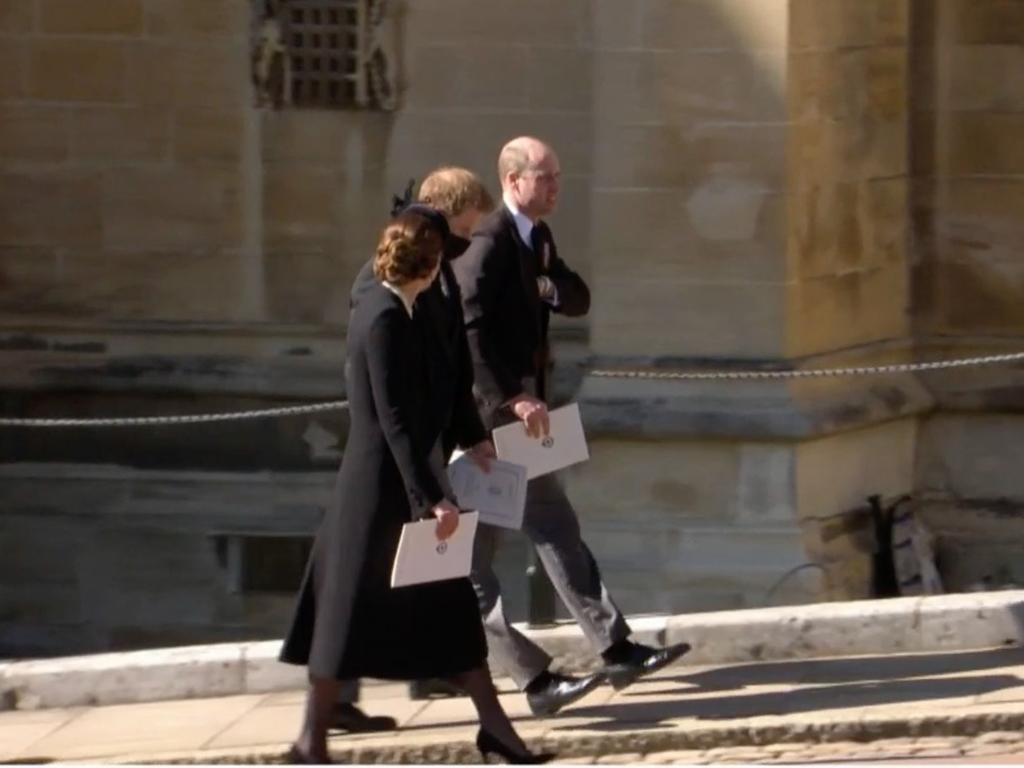 Kate Middleton, Prince Harry and Prince William walking together before the Duchess of Cambridge dropped back and let the brothers walk side-by-side. Picture: Supplied