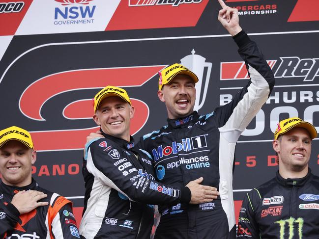 Lee Holdsworth and Chaz Mostert celebrating on the podium after winning the Repco Bathurst 1000 at Mount Panorama today. Picture: Tim Hunter.