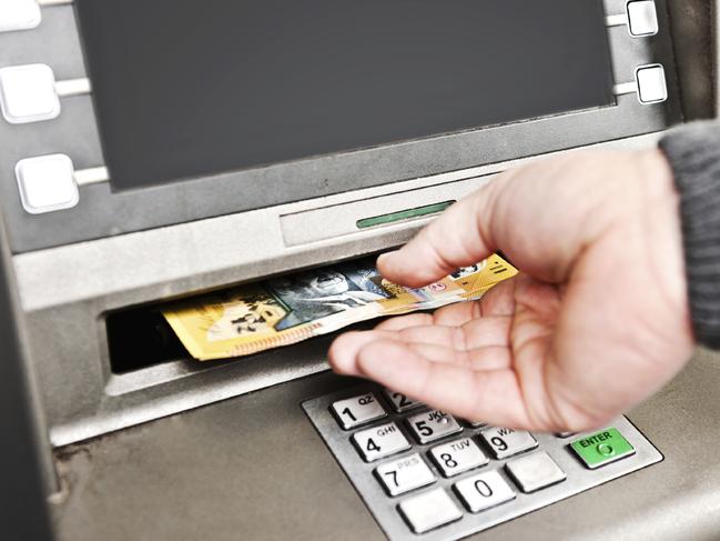 withdrawing money from an atm, collecting australian $50 notes