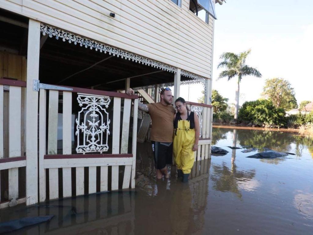 Queen St residents Courtney Azzopardi, Jay Waters and his mother Chris spent two days building a levee around their home.