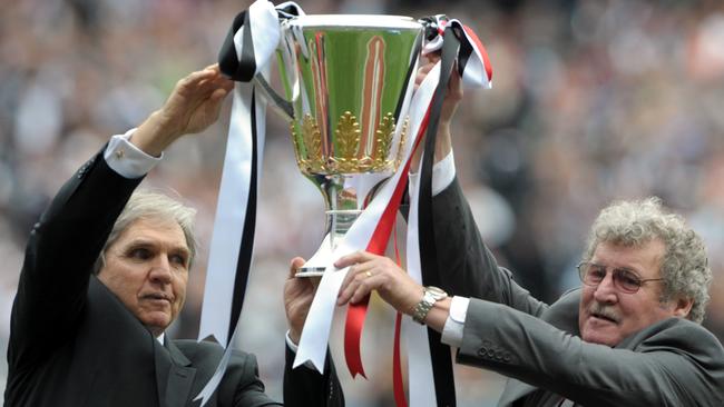 Peter McKenna (left) and Kevin Neale with the premiership cup at the 2010 Grand Final.