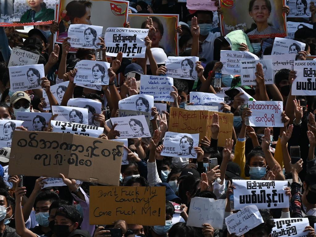 Pro-democracy protesters hold placards in Yangon following the military takeover earlier last week. Picture: Ye Aung Thu / AFP