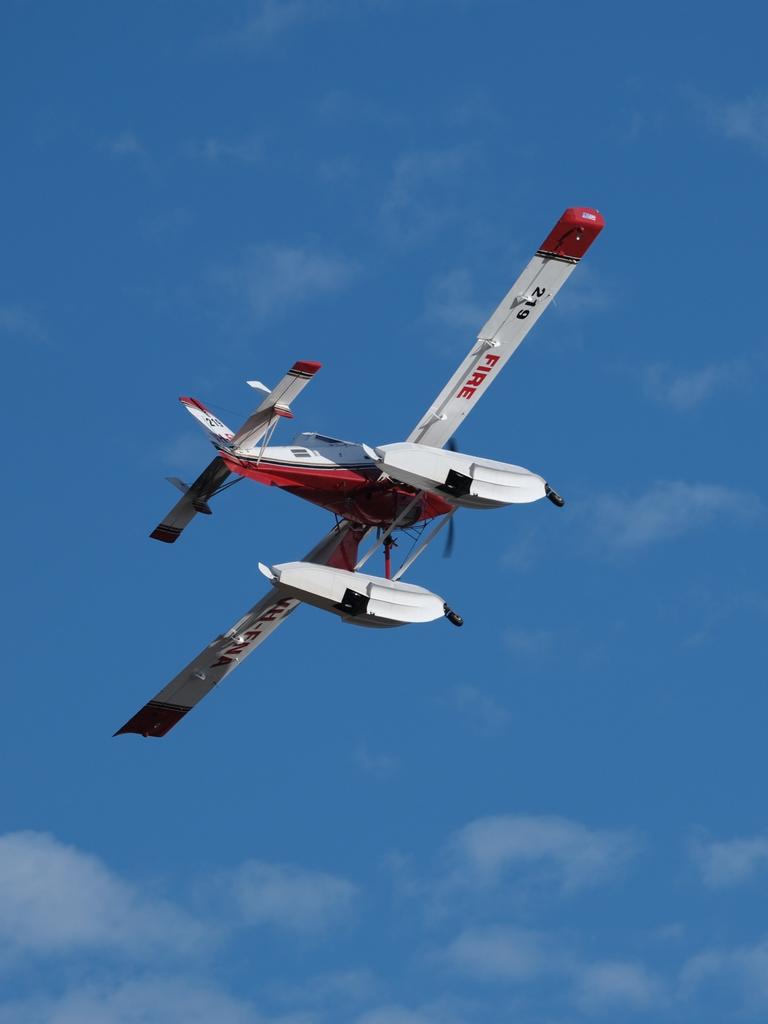 Water bombing runs made to tame a bushfire threatening Dolphin Sands in the early morning of Monday. This comes after the area was hit by a devastating bushfire in November 2023. Picture: Tony Fist