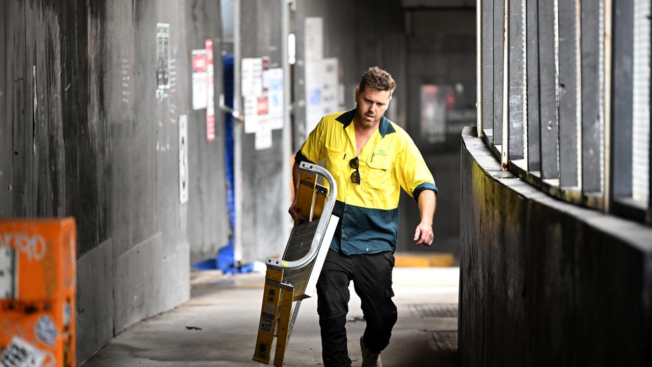 Sub-contractors and tradesmen pack up their equipment and walk off the 443 Queens Street construction site in Brisbane.