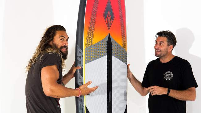 Aquaman Jason Momoa with Gold Coast surf shop owner Tim Beban designing their custom board together. Photos are the property of The Surfboard Warehouse