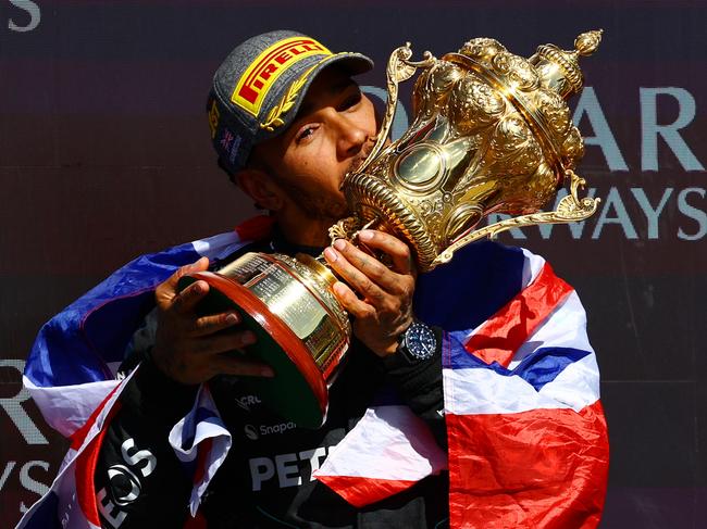 NORTHAMPTON, ENGLAND - JULY 07: Race winner Lewis Hamilton of Great Britain and Mercedes celebrates on the podium during the F1 Grand Prix of Great Britain at Silverstone Circuit on July 07, 2024 in Northampton, England. (Photo by Mark Thompson/Getty Images) *** BESTPIX ***