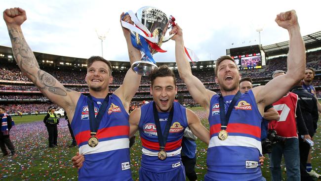 Clay Smith celebrates the Bulldogs’ premiership with teammates Luke Dahlhaus and Matthew Boyd. Picture: Michel Klein