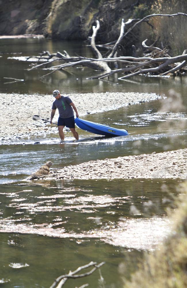 Aaron Graham on the Macquarie River, where long stretches are too shallow to even paddle a kayak. Picture: Dean Marzolla