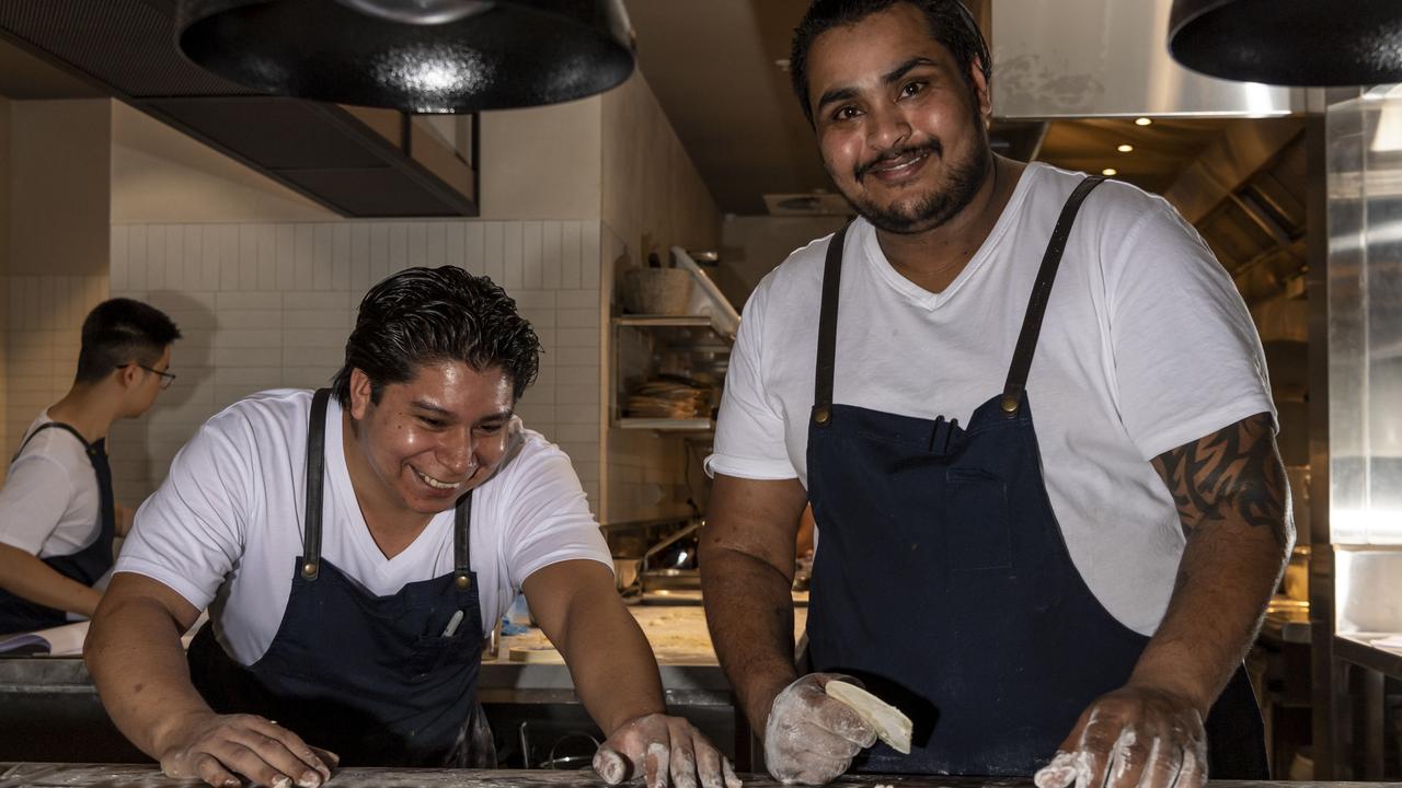 Jay Rao, right, prepares a dish with a colleague. Picture: Monique Harmer