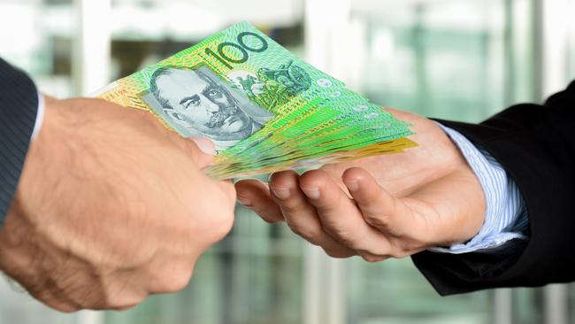 Hands of businessmen passing money, Australia dollar bills