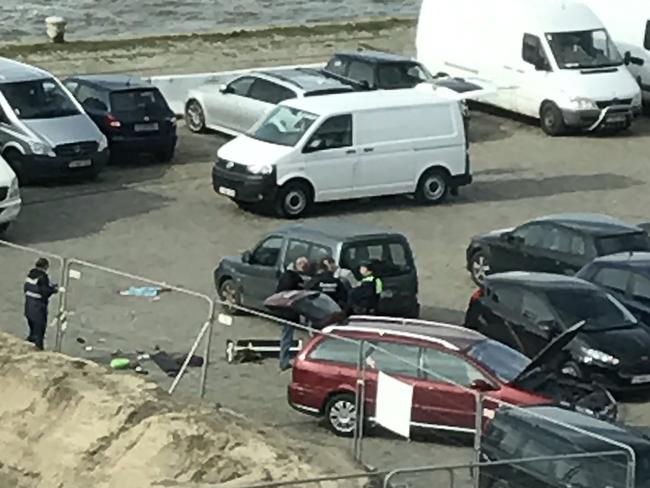 Police stand next to a car that a driver tried to plough into a crowd at high-speed in a shopping area in the port city of Antwerp. Picture: AFP/Handout/Twitter/Anouk Leemans