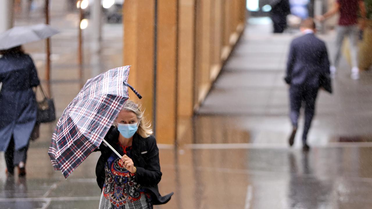 A woman is seen making her way through Sydney CBD on Thursday. Picture: NCA NewsWire / Damian Shaw