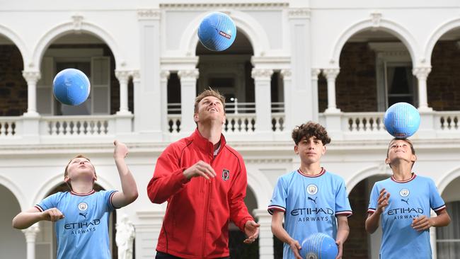 Rostrevor students Henry Askem, 11, Christian Tassotti, 14, Ryder Dalton, 11, with former Socceroo Daniel Mullen. Picture: Tricia Watkinson