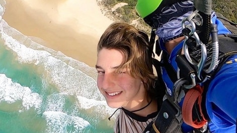 Fly high: Balin Stewart, pictured parachuting over the ocean he loved, was an active teenager.