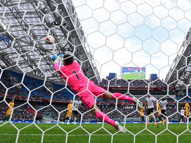 Australia's goalkeeper Mathew Ryan dives to block a shot on goal.