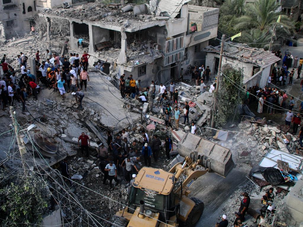 Palestinian emergency services and local citizens search for victims in buildings destroyed during Israeli air raids in the southern Gaza Strip in Khan Yunis. Picture: Getty Images