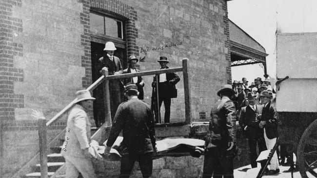 A body (believed to be William John Shaw) being removed from the train station by local undertaker Dave Mangelsdorf (left, in white) and placed into the morgue horse cart. His 18-year-old assistant, Bill Waghorn, is pictured middle of the back row. This photo is owned by Joyce Douglas (Mr WaghornÕs daughter).