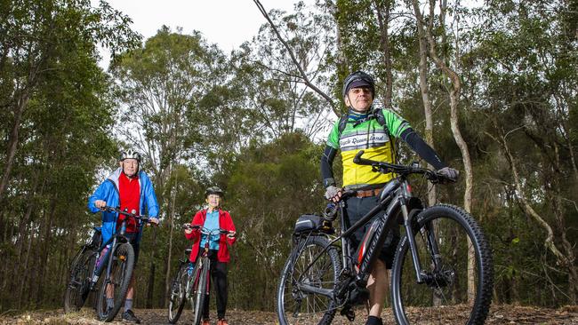 Cyclists Paul Casbolt, front, with John and Julie Shera at Logan Village. Picture: Richard Walker