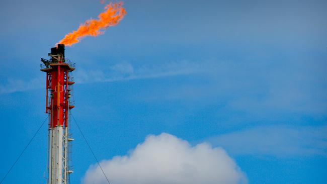 A flame blazes on top of a flare stack at the Queensland Curtis Liquefied Natural Gas (QCLNG) project site, operated by QGC Pty, a unit of Royal Dutch Shell Plc, in Gladstone, Australia, on Wednesday, June 15, 2016. Gas from more than 2,500 wells travels hundreds of miles by pipeline to the project, where it's chilled and pumped into 10-story-high tanks before being loaded onto massive ships. Photographer: Patrick Hamilton/Bloomberg via Getty Images