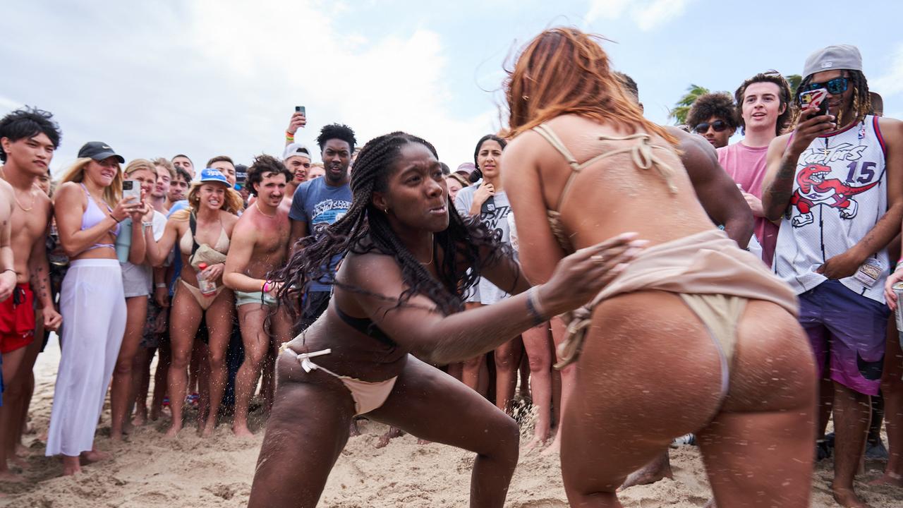 Several scantily clad women also joined in on the action, tackling and wrestling one another to the ground. Picture: Romain Maurice/MEGA