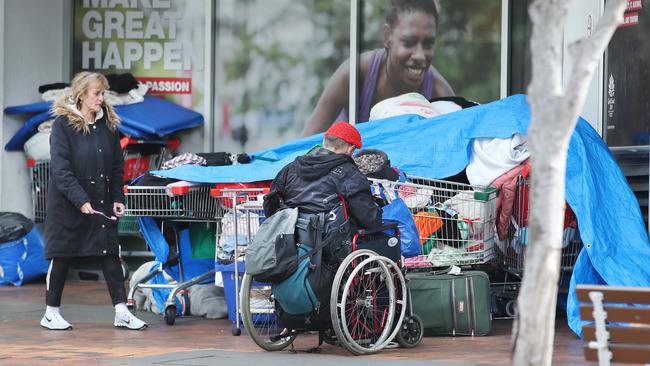 Homeless people store their belongings under a giant tarp in the middle of town at Nerang St Southport. Picture: Glenn Hampson