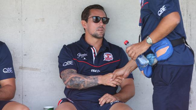 Mitchell Pearce watches on.