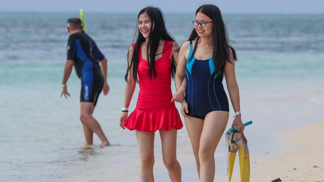 Chinese tourists Anna Yung and Doris Chen from Beijing enjoying the tropical winter on Green Island, off Cairns, on the Great Barrier Reef  before heading to the rainforest on the Tablelands then onto Sydney. Picture: Marc McCormack