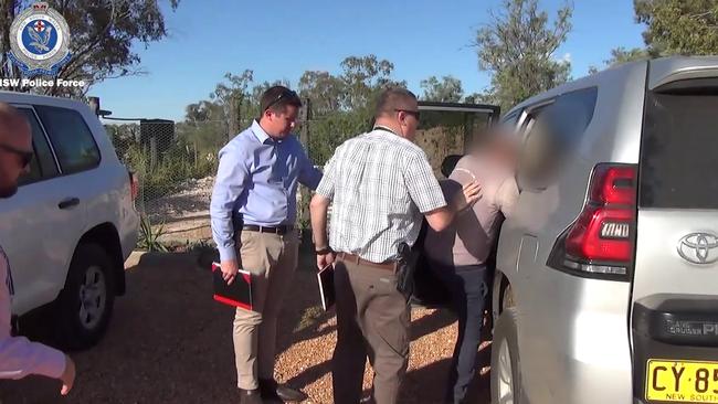 Detectives lead Stefanato away after his arrest. Picture: NSW Police