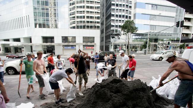 Sandbags are prepared as roads were cut in the Brisbane CBD.