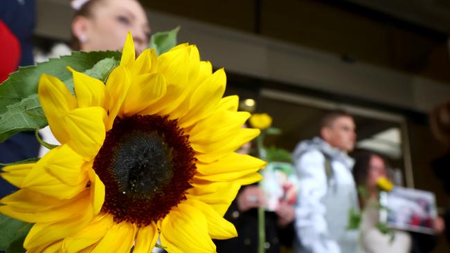 Supporters of Michelle Foster brought sunflowers to court to honour her memory. Picture: NCA NewsWire/Kelly Barnes.