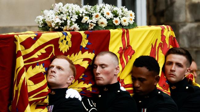 Pallbearers carry the coffin of the Queen into the Palace of Holyroodhouse in Edinburgh on Sunday. Picture: Getty Images