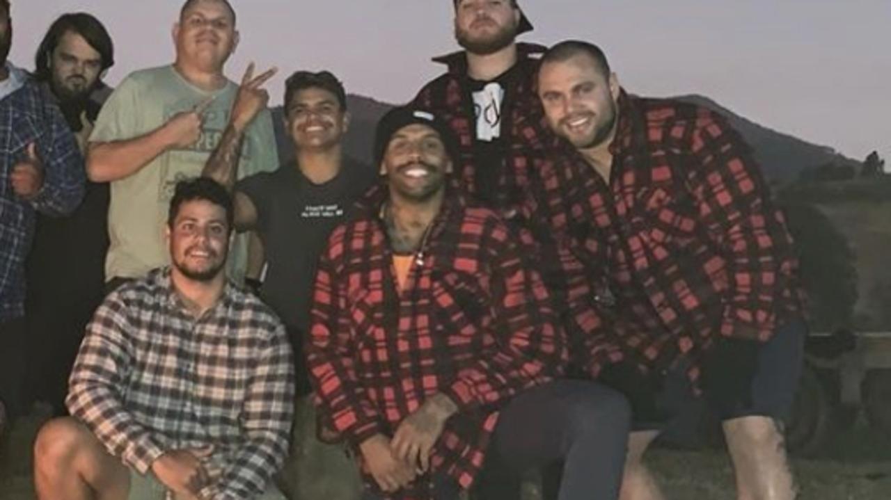 Josh Addo Carr and Latrell Mitchell with a group of people on a Taree property.