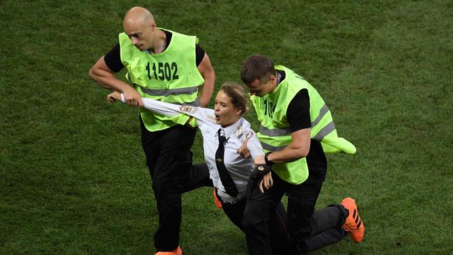 A protester is escorted off the pitch during the Russia 2018 World Cup final.