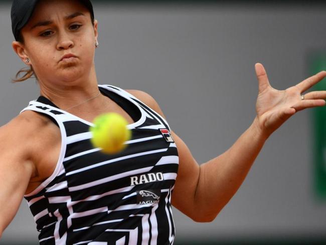 Australia's Ashleigh Barty eyes the ball as she returns the ball to Amanda Anisimova.