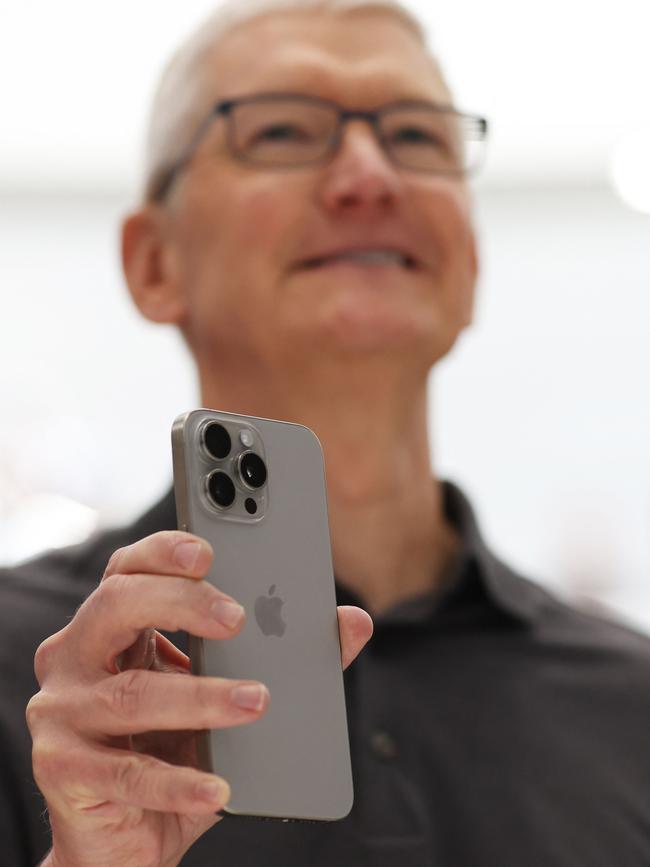 Apple CEO Tim Cook holds up a new iPhone 15 Pro. Picture: AFP