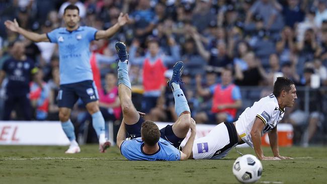 Mark Milligan of Macarthur FC tackles Trent Buhagiar of Sydney FC before being given a red card during the A-League match on Saturday. Picture: Ryan Pierse/Getty Images