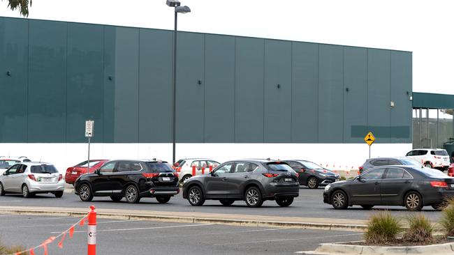 People queue for a Covid vaccination at Australia’s first drive-though clinic at the old Bunnings store in Melton. Picture: Andrew Henshaw