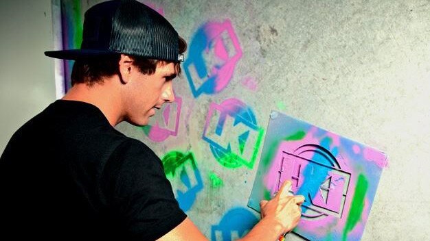 Jason Daniel painting the old LKI logo.