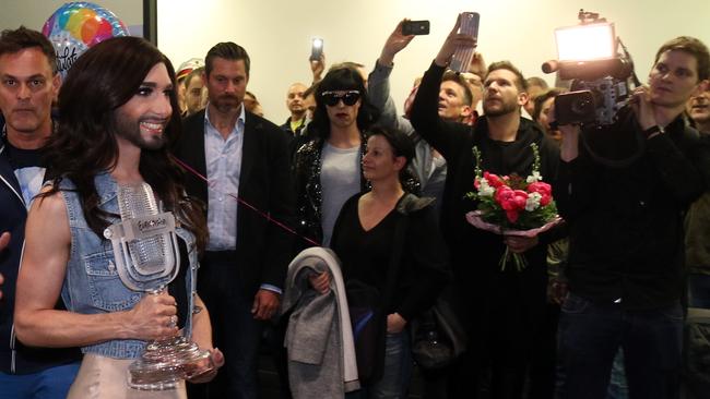 Homecoming ... Conchita Wurst arrives with the trophy at the airport in Vienna.