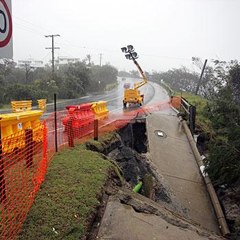 The footpath and some of the road have fallen down on David Low Way at Sunrise Beach. The road was still open at 3.30pm yesterday but closed by Noosa Council. Photo: Cade Mooney