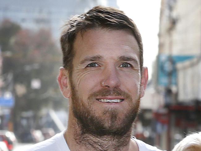 Dane Swan and his dog Barney off for walkies down Chapel Street. Dane is supporting his local traders in Prahran with buying local message.  Picture: David Caird