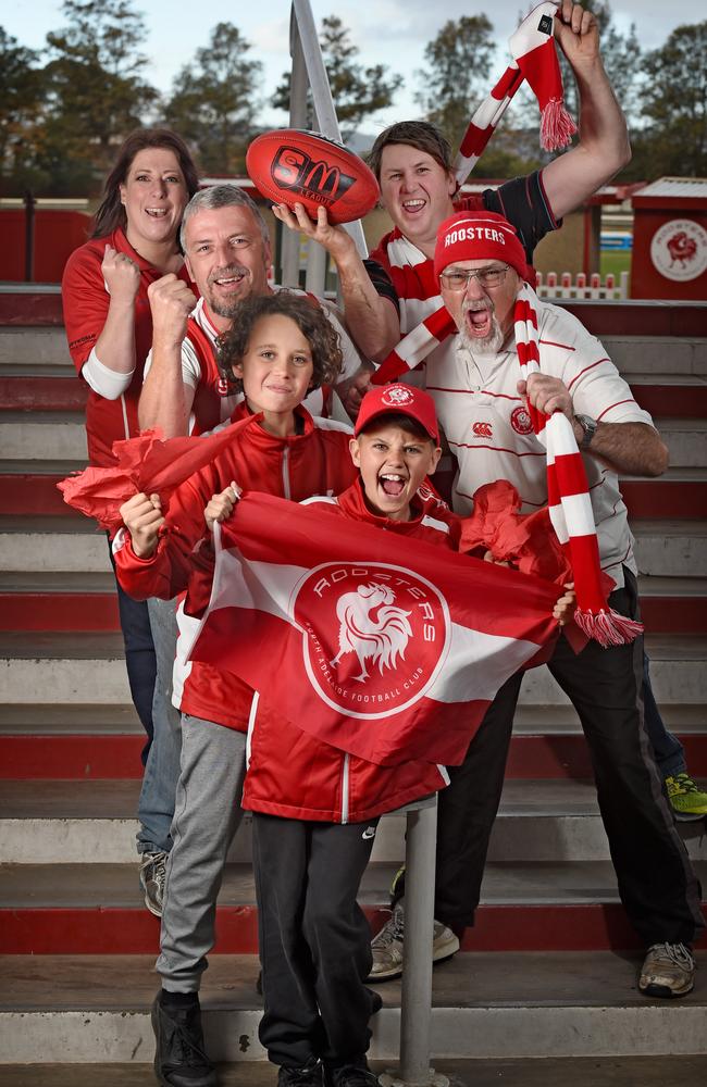 North Adelaide fans Nicky and Kristian Piep, brothers Jai and Levi with Simon Russell and Robbie Weaver celebrate at Roosters’ training on Tuesday. Picture: Naomi Jellicoe