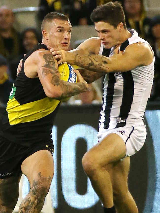 Dustin Martin fends off Jack Crisp. Picture: George Salpigtidis